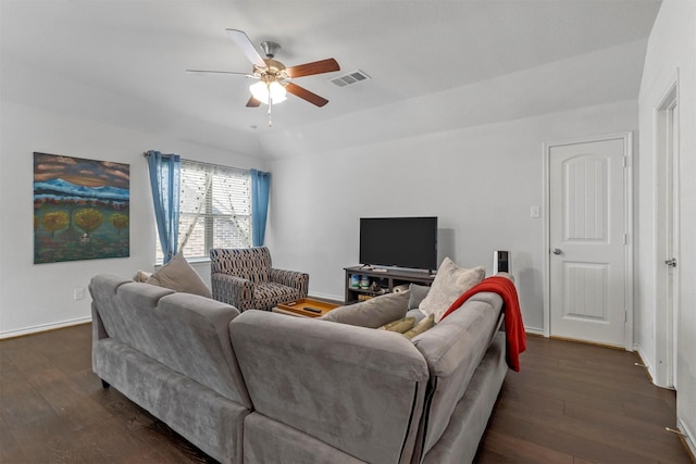 living area featuring dark wood-style floors, lofted ceiling, visible vents, and baseboards