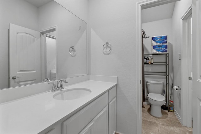 bathroom featuring tile patterned flooring, vanity, and toilet