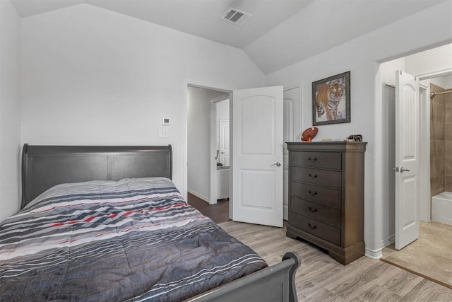 bedroom featuring lofted ceiling, wood finished floors, visible vents, and baseboards