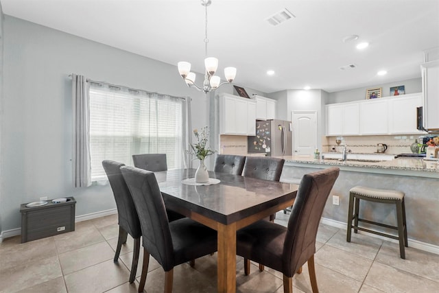 dining area with light tile patterned floors, baseboards, visible vents, a chandelier, and recessed lighting