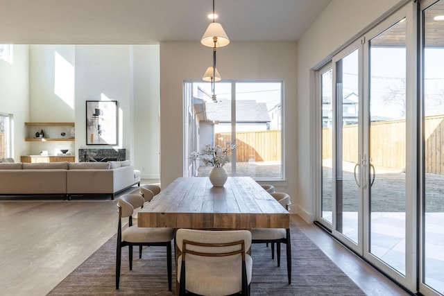 dining area with french doors, dark wood finished floors, and baseboards