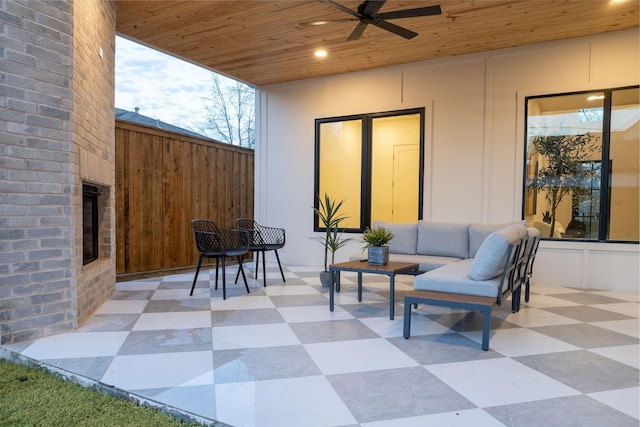 view of patio / terrace featuring fence, an outdoor hangout area, and a ceiling fan