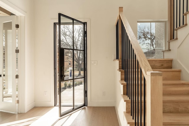 interior space featuring stairway, wood finished floors, and baseboards