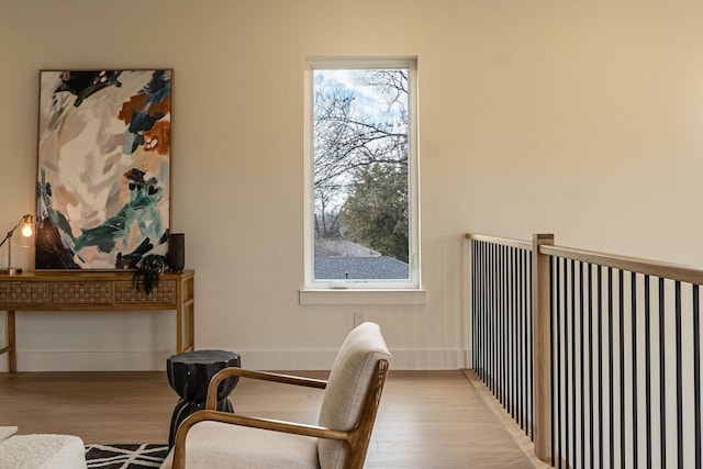 living area with wood finished floors and baseboards