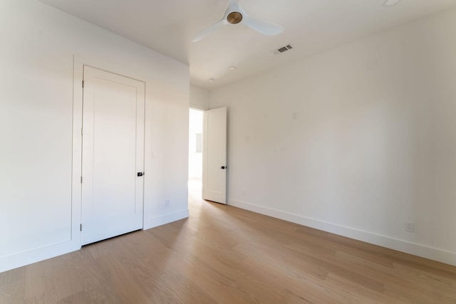 unfurnished bedroom with baseboards, ceiling fan, visible vents, and light wood-style floors