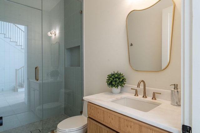 full bath featuring toilet, a shower stall, and vanity