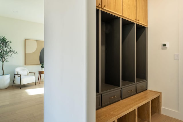 mudroom with baseboards and light wood-style flooring