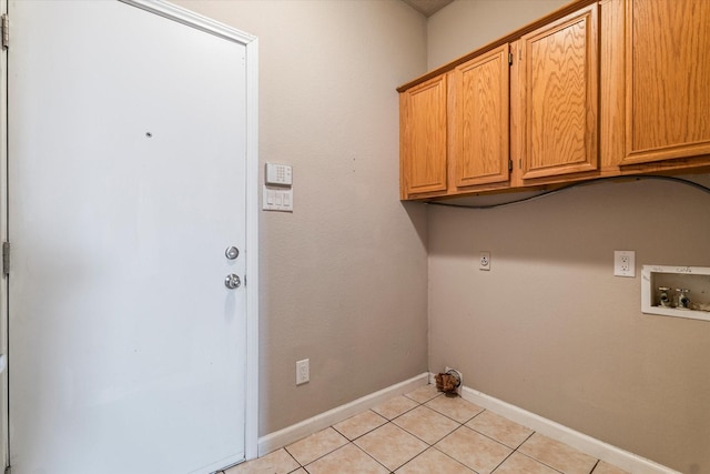 laundry room featuring cabinet space, hookup for a washing machine, baseboards, and light tile patterned flooring