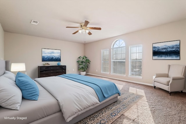 bedroom featuring ceiling fan, carpet floors, visible vents, and baseboards