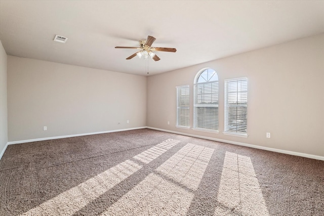 unfurnished room with baseboards, visible vents, ceiling fan, and carpet flooring