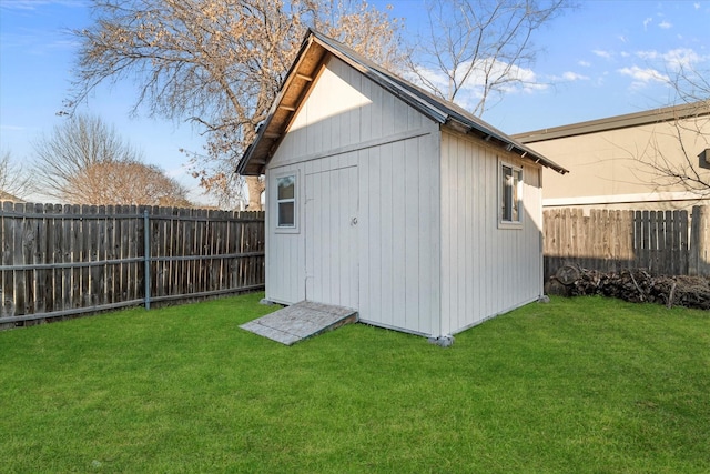 view of outdoor structure with an outbuilding and a fenced backyard