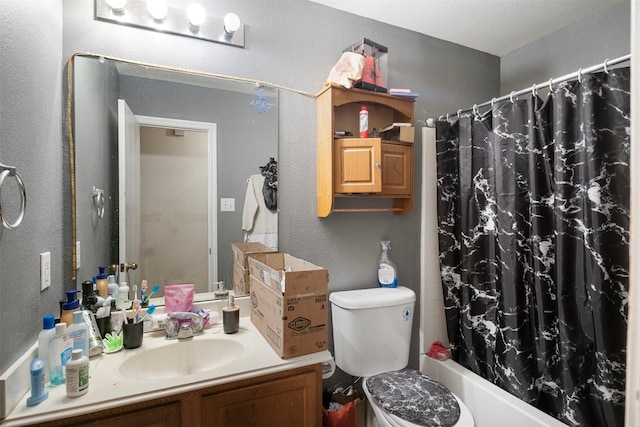 full bath featuring toilet, a textured wall, shower / bathtub combination with curtain, and vanity