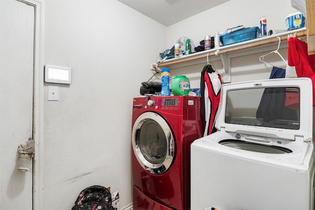 clothes washing area with laundry area and washing machine and clothes dryer