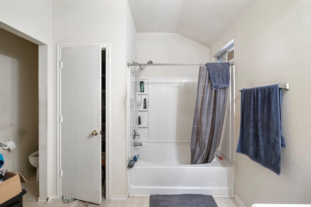 bathroom featuring lofted ceiling, shower / bath combo with shower curtain, toilet, and baseboards