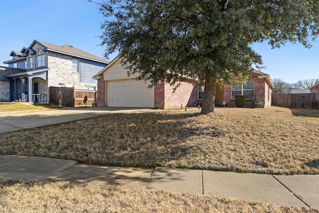 view of front of house with concrete driveway, brick siding, fence, and an attached garage