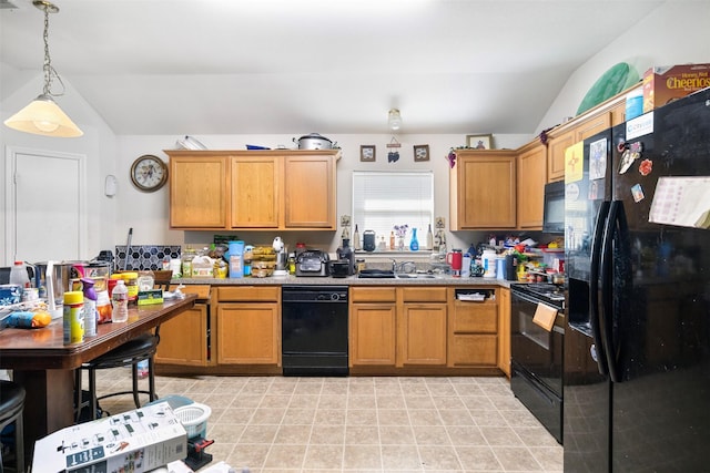 kitchen with lofted ceiling, black appliances, a sink, and decorative light fixtures