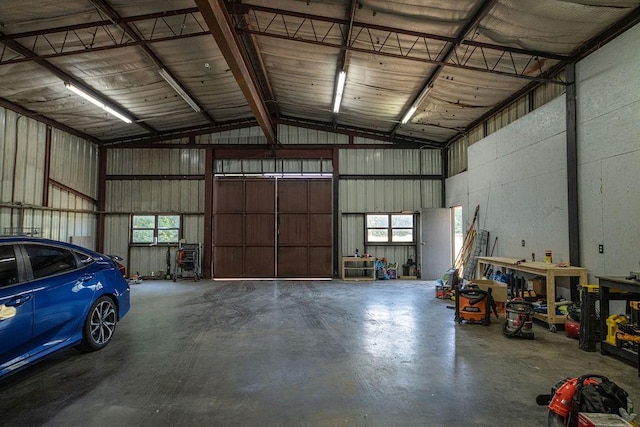 garage with a workshop area and metal wall