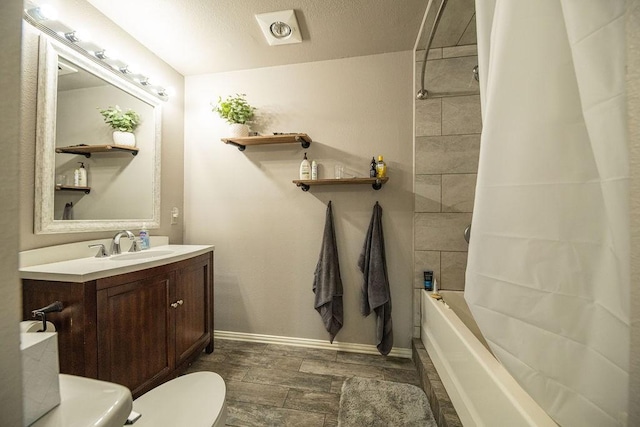 full bathroom with toilet, baseboards, shower / bath combination with curtain, and vanity