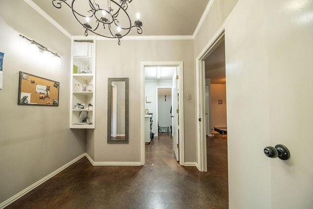 corridor with baseboards, finished concrete floors, ornamental molding, and a chandelier