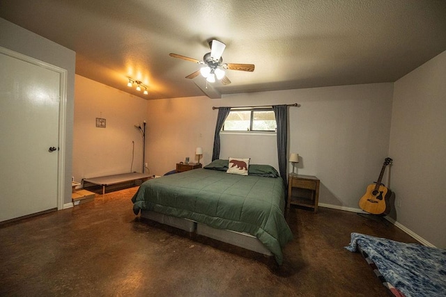 bedroom featuring ceiling fan, baseboards, and a textured ceiling