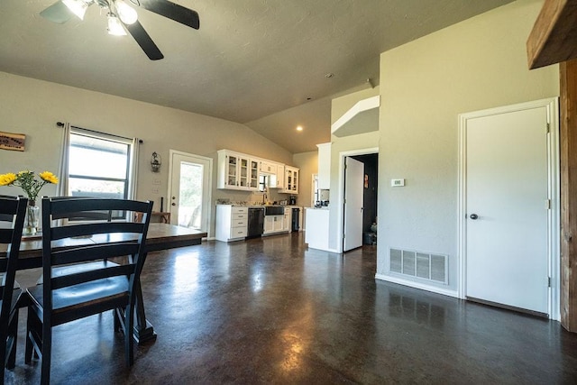 interior space featuring finished concrete floors, visible vents, vaulted ceiling, and ceiling fan