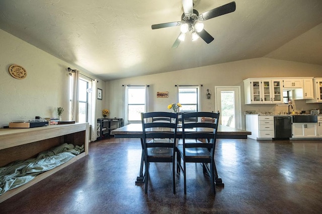 dining room featuring lofted ceiling, finished concrete flooring, and a healthy amount of sunlight