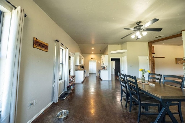 dining room with baseboards, concrete floors, visible vents, and a ceiling fan