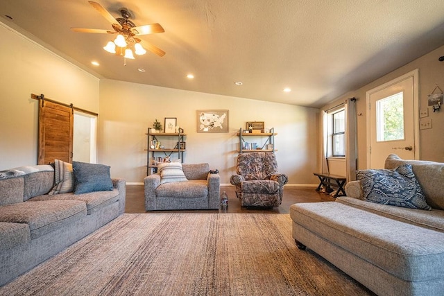 living room featuring a barn door, baseboards, a ceiling fan, a textured ceiling, and recessed lighting