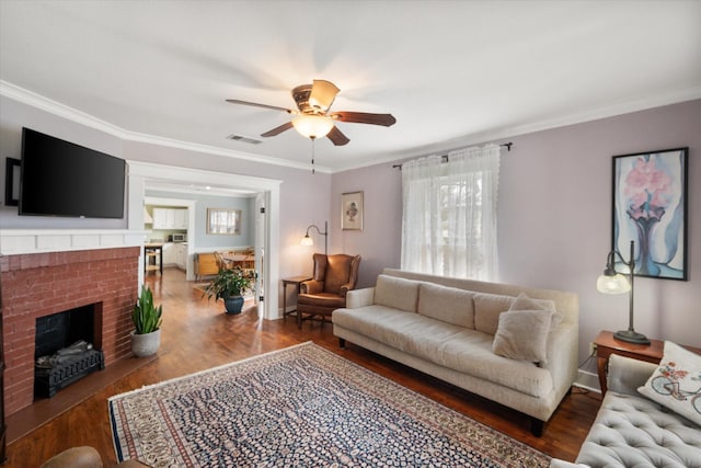 living room with ornamental molding, wood finished floors, and visible vents