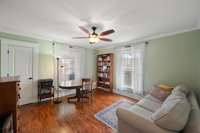 interior space with ceiling fan, ornamental molding, wood finished floors, and baseboards