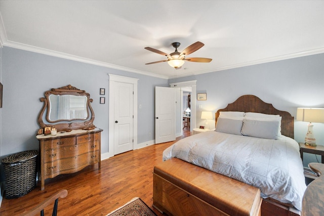 bedroom with ornamental molding, ceiling fan, baseboards, and wood finished floors