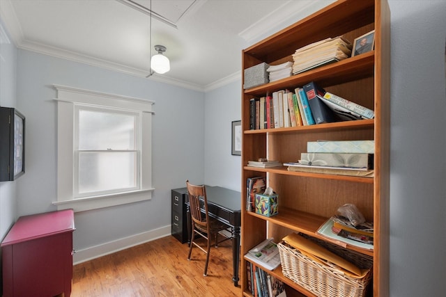 office featuring ornamental molding, attic access, baseboards, and wood finished floors