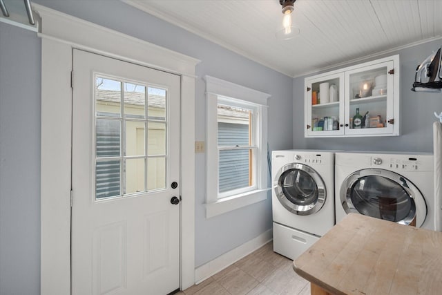 laundry room featuring light tile patterned floors, ornamental molding, washer and dryer, laundry area, and baseboards