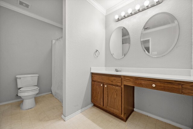 bathroom featuring tile patterned flooring, crown molding, vanity, and toilet