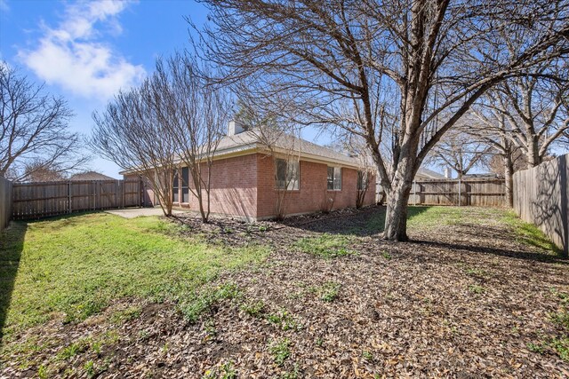 view of yard with a patio area and a fenced backyard