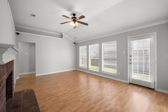 unfurnished living room featuring a brick fireplace, visible vents, crown molding, and a healthy amount of sunlight