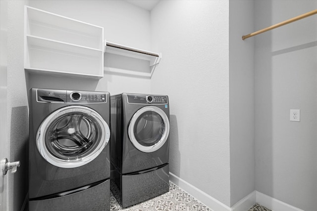 laundry room featuring laundry area, washing machine and dryer, and baseboards