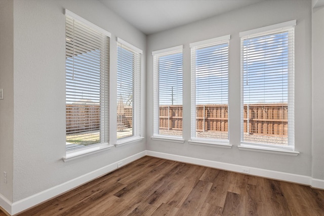 interior space featuring baseboards and wood finished floors