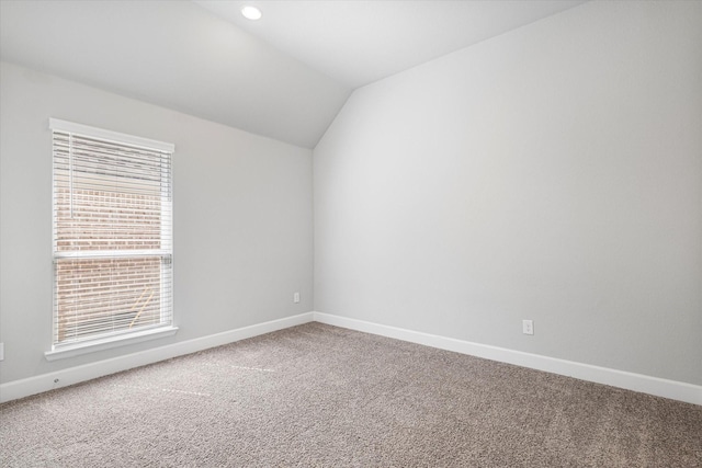 unfurnished room with vaulted ceiling, carpet flooring, recessed lighting, and baseboards