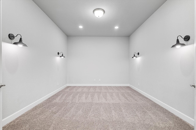 empty room featuring recessed lighting, baseboards, and carpet