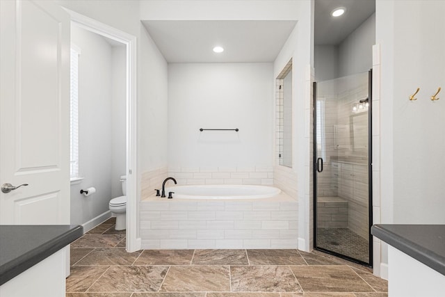 bathroom with vanity, a shower stall, toilet, and a bath