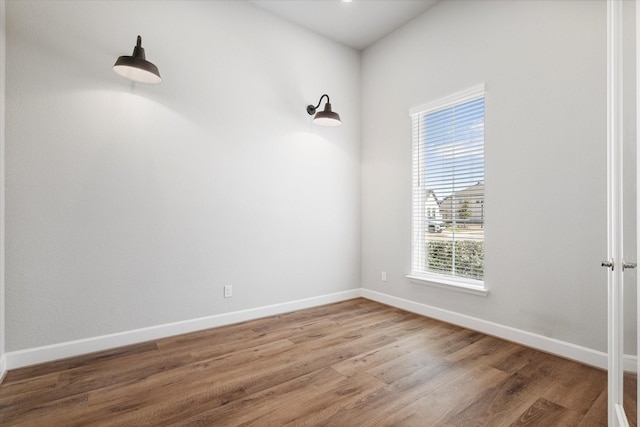 empty room featuring baseboards and wood finished floors