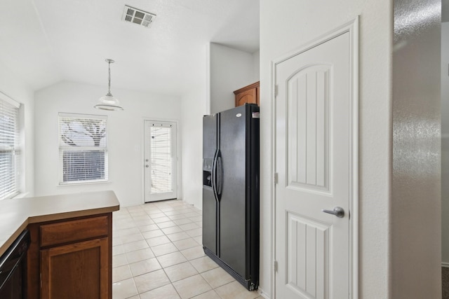 kitchen featuring lofted ceiling, light tile patterned flooring, visible vents, black appliances, and pendant lighting