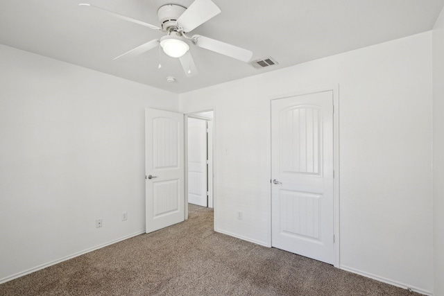 unfurnished bedroom with carpet floors, visible vents, ceiling fan, and baseboards