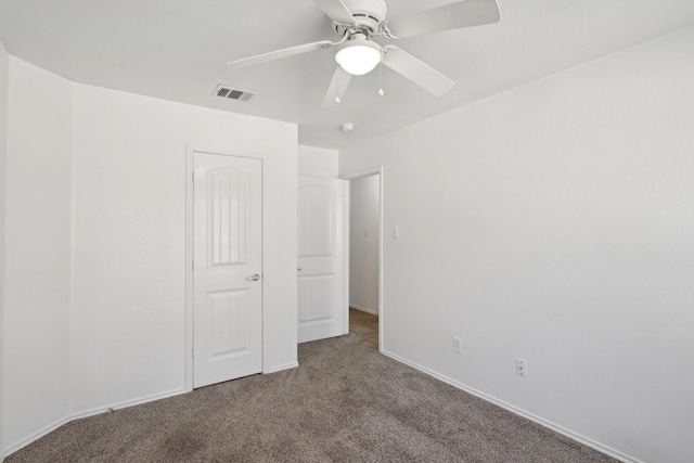 unfurnished bedroom with ceiling fan, carpet floors, visible vents, and baseboards