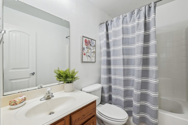 bathroom featuring toilet, shower / bath combo with shower curtain, and vanity