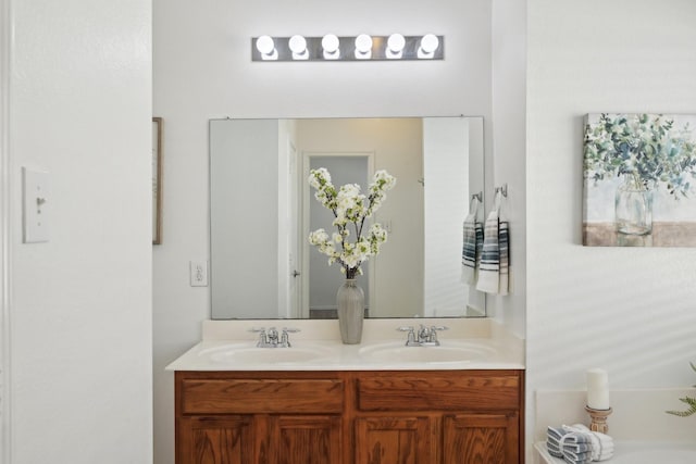 bathroom featuring a sink and double vanity