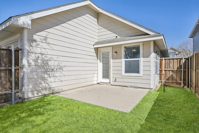 back of house featuring a yard, fence, and a patio