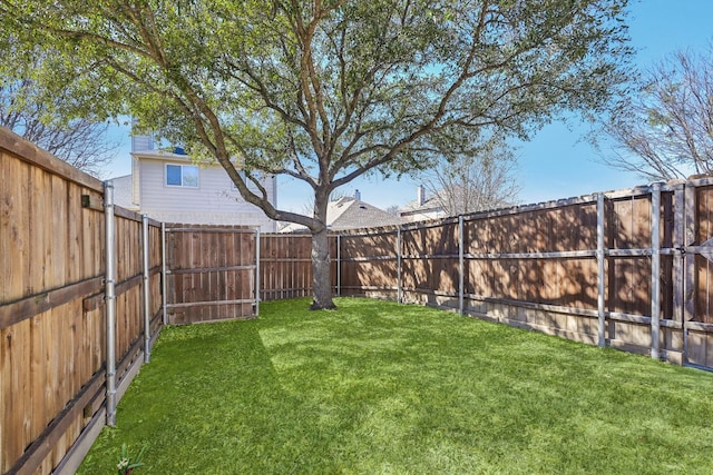 view of yard with a fenced backyard