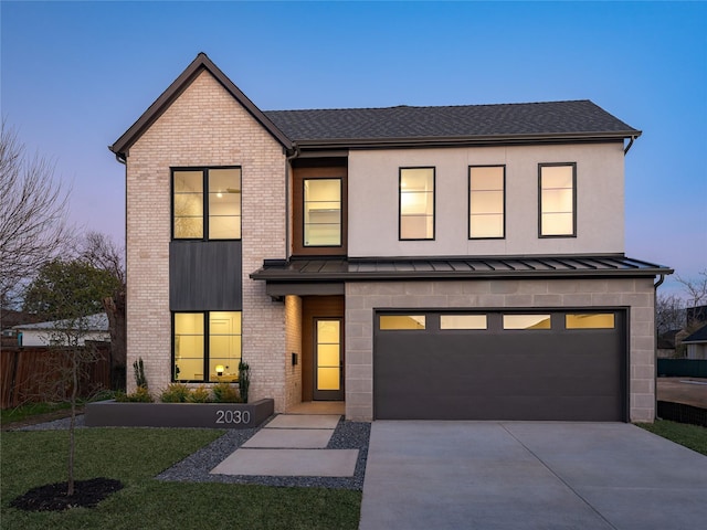 view of front of property with a standing seam roof, brick siding, metal roof, and concrete driveway